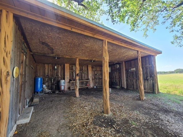 view of patio with an outdoor structure and a pole building