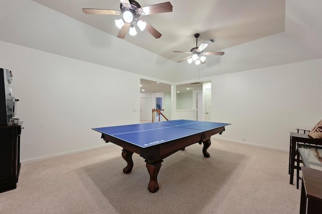 recreation room featuring light colored carpet, a ceiling fan, and baseboards