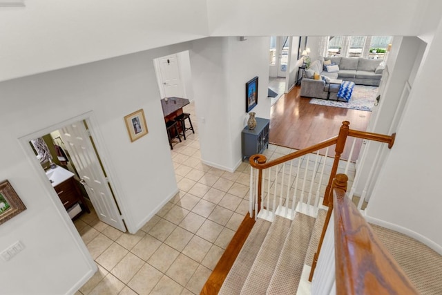 stairway with tile patterned flooring and baseboards