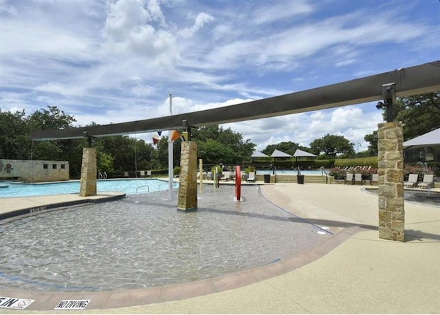 view of home's community with a pool and a patio area