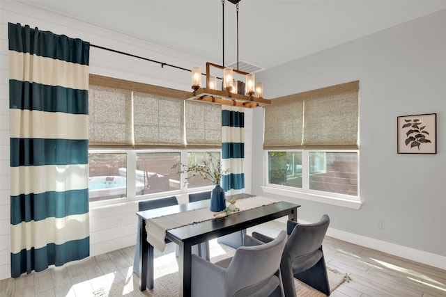 1506 Fox Sparrow Trl, Cedar Park, TX 78613 - dining space with healthy amount of natural light, a chandelier, light wood-style floors, and baseboards