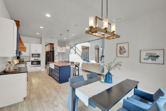 1506 Fox Sparrow Trl, Cedar Park, TX 78613 - dining area with light wood-type flooring, recessed lighting, and a chandelier