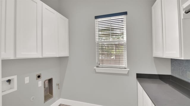 1506 Fox Sparrow Trl, Cedar Park, TX 78613 - laundry area with hookup for a gas dryer, cabinet space, hookup for an electric dryer, baseboards, and washer hookup