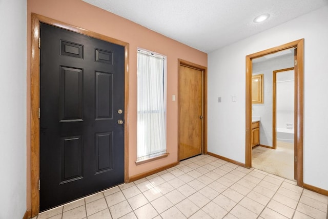 6820 N Cypress Pt Unit 22, Austin, TX 78746 - foyer with baseboards and light tile patterned floors