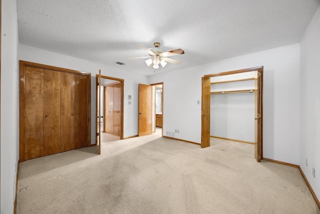 6820 N Cypress Pt Unit 22, Austin, TX 78746 - unfurnished bedroom featuring light carpet, baseboards, ceiling fan, and a textured ceiling