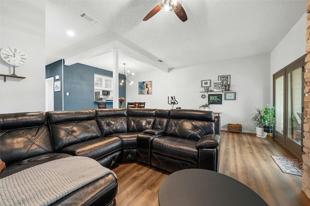 living area with ceiling fan, a textured ceiling, wood finished floors, and baseboards