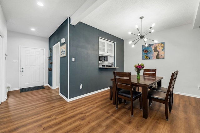 dining room featuring a chandelier, wood finished floors, beam ceiling, baseboards, and recessed lighting