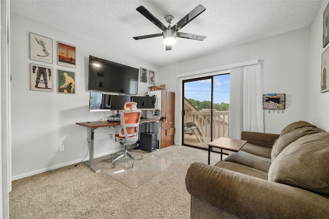 office space with ceiling fan, a textured ceiling, baseboards, and carpet floors