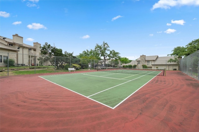 view of tennis court with fence and community basketball court