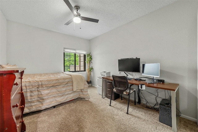bedroom featuring carpet floors, a desk, ceiling fan, a textured ceiling, and baseboards