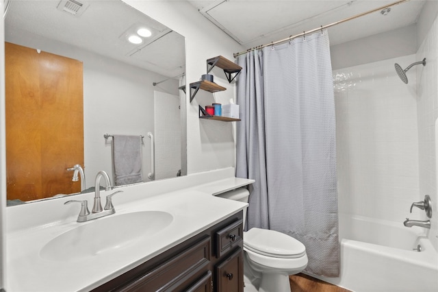 bathroom featuring toilet, shower / tub combo with curtain, and vanity