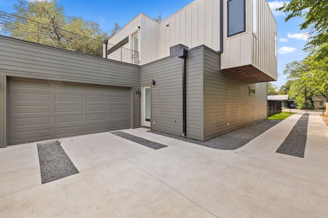 4407 Merle Dr Unit A, Austin, TX 78745 - view of side of home featuring driveway, a balcony, board and batten siding, and a garage