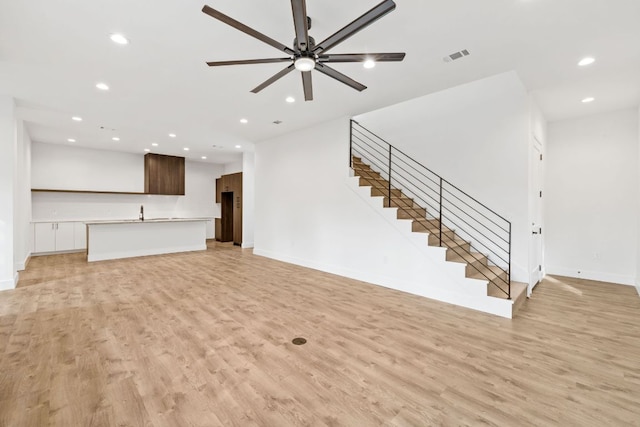 4407 Merle Dr Unit A, Austin, TX 78745 - unfurnished living room with recessed lighting, stairs, light wood-type flooring, and a ceiling fan
