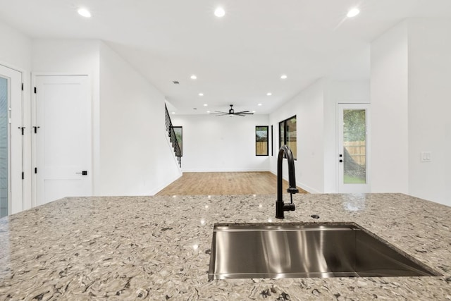 4407 Merle Dr Unit A, Austin, TX 78745 - kitchen featuring a sink, recessed lighting, light stone counters, a ceiling fan, and wood finished floors