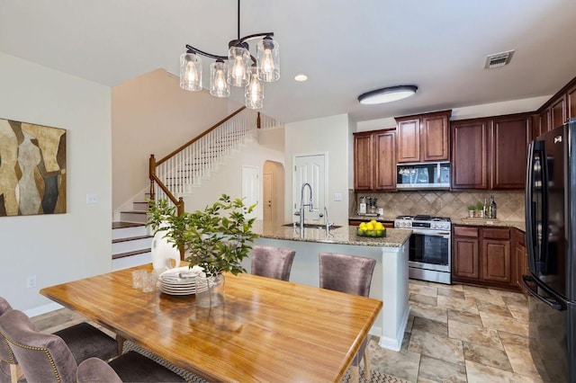 409 S Frontier Ln, Cedar Park, TX 78613 - dining space with stairway, arched walkways, a chandelier, recessed lighting, and light stone finish flooring