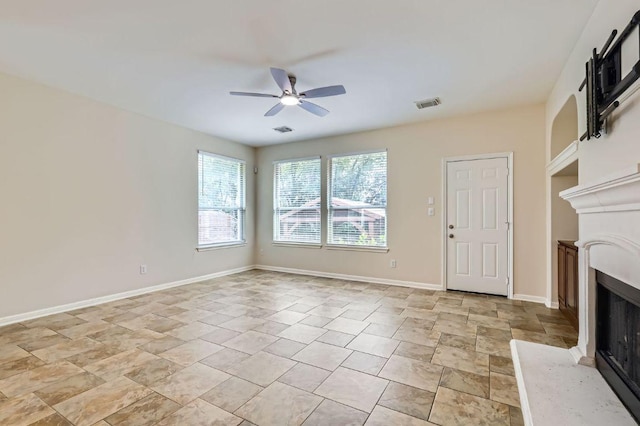409 S Frontier Ln, Cedar Park, TX 78613 - unfurnished living room with a fireplace, a ceiling fan, light stone finish floors, and baseboards