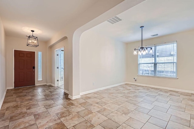 409 S Frontier Ln, Cedar Park, TX 78613 - entrance foyer with a chandelier, arched walkways, baseboards, and stone finish flooring