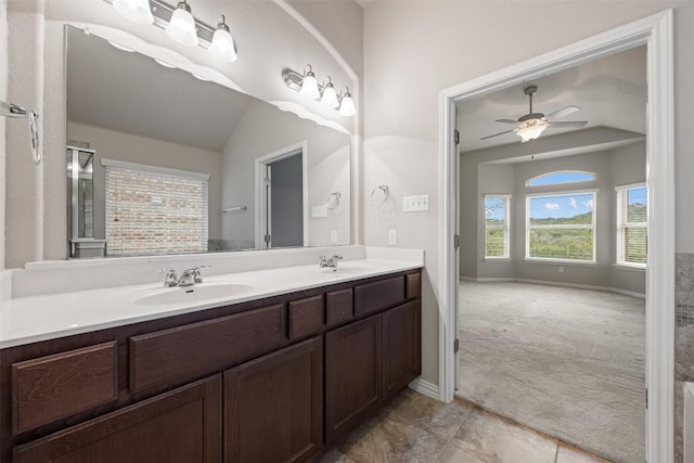 bathroom featuring a ceiling fan, double vanity, tile patterned floors, and baseboards