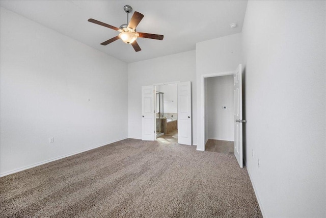 unfurnished bedroom featuring light carpet, ensuite bathroom, ceiling fan, and baseboards