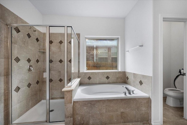 bathroom with a stall shower, a bath, and toilet