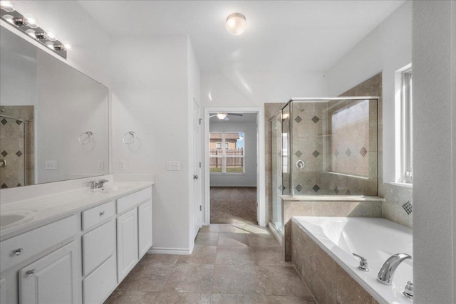 bathroom with a shower stall, a bath, double vanity, and a ceiling fan