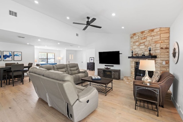 3305 Eldorado Trl, Austin, TX 78748 - living area with light wood-style flooring, a ceiling fan, vaulted ceiling, recessed lighting, and a stone fireplace