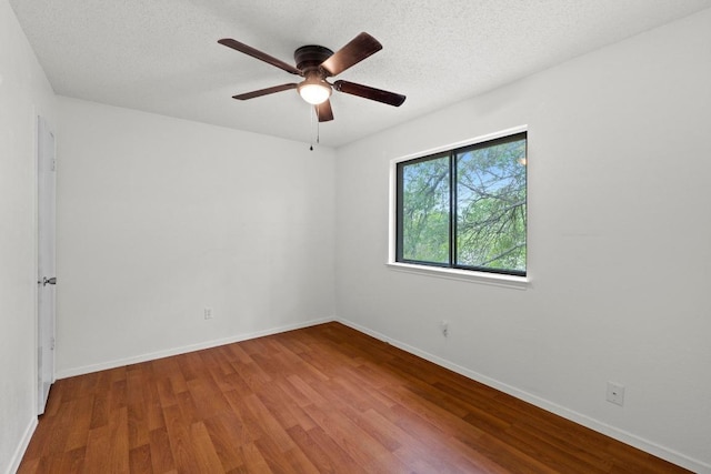 1300 Tuxford Cv, Austin, TX 78753 - unfurnished room featuring wood finished floors, a ceiling fan, baseboards, and a textured ceiling