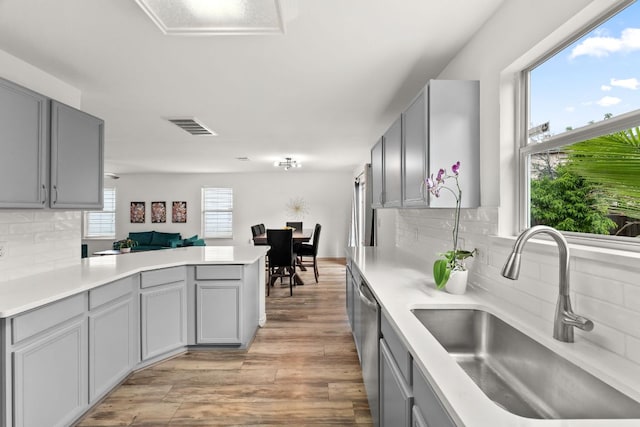 kitchen featuring a sink, gray cabinets, and light countertops