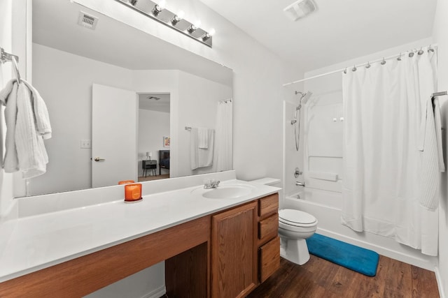 bathroom with wood finished floors, vanity, shower / bath combo, and toilet