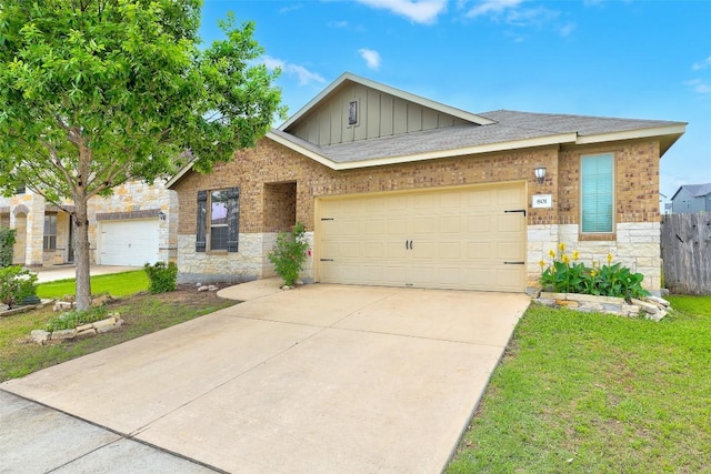 801 Vaughn St, Georgetown, TX 78628 - view of front of house featuring board and batten siding, stone siding, driveway, an attached garage, and roof with shingles