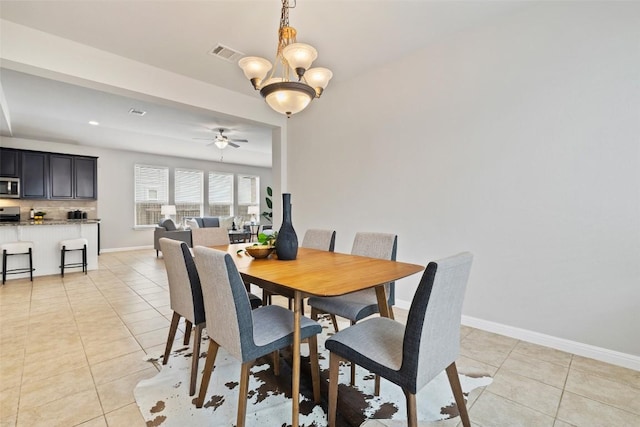 801 Vaughn St, Georgetown, TX 78628 - dining room with light tile patterned floors, ceiling fan, a chandelier, and baseboards