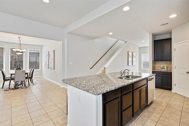 801 Vaughn St, Georgetown, TX 78628 - kitchen featuring light tile patterned floors, stainless steel dishwasher, a sink, light stone counters, and recessed lighting
