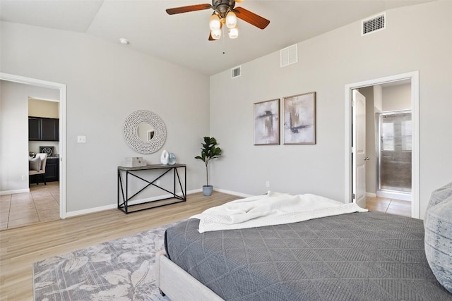 801 Vaughn St, Georgetown, TX 78628 - bedroom featuring light wood-type flooring, baseboards, a ceiling fan, and ensuite bath