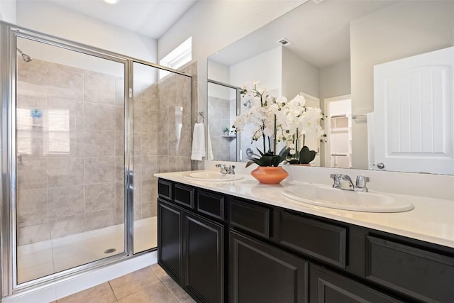 801 Vaughn St, Georgetown, TX 78628 - bathroom featuring a stall shower, double vanity, and tile patterned floors
