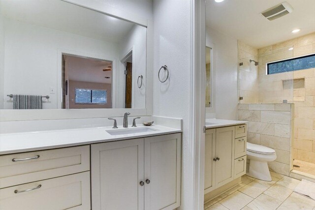 3409 Sanderling Trl, Austin, TX 78746 - bathroom featuring a tile shower, vanity, toilet, and radiator heating unit