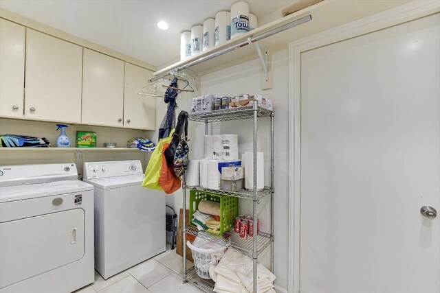 3409 Sanderling Trl, Austin, TX 78746 - clothes washing area featuring washing machine and clothes dryer, cabinet space, and light tile patterned floors