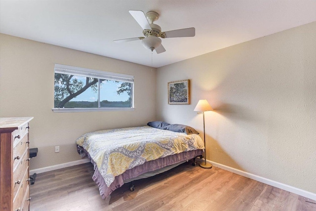 3409 Sanderling Trl, Austin, TX 78746 - bedroom with baseboards, wood finished floors, and ceiling fan