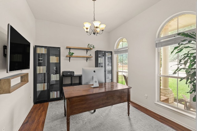 office featuring wood finished floors, a chandelier, lofted ceiling, and baseboards