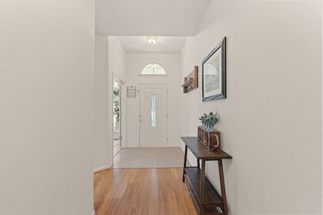 entryway with light wood-type flooring and baseboards
