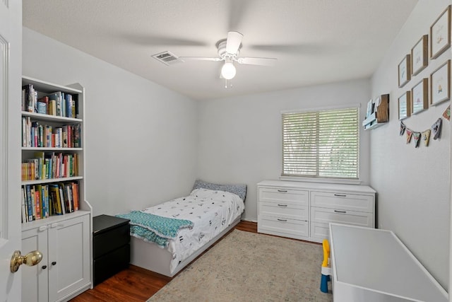 bedroom featuring dark wood-style floors and a ceiling fan