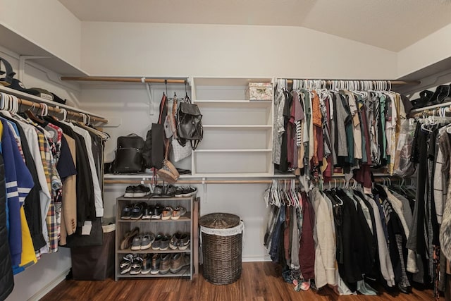 spacious closet with wood finished floors and vaulted ceiling