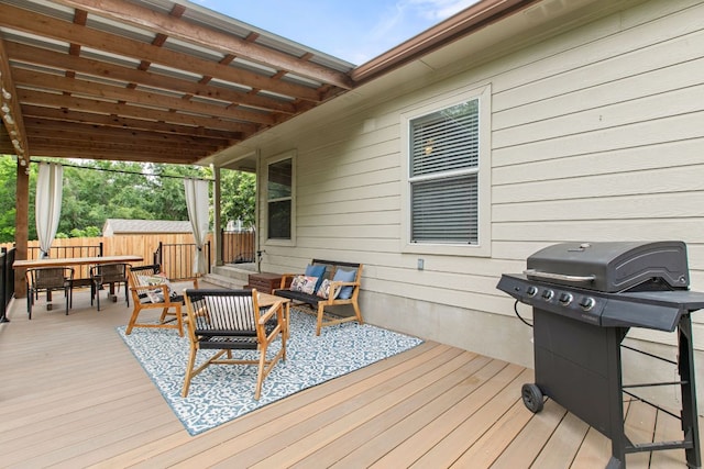 wooden deck featuring outdoor dining area, an outdoor hangout area, a fenced backyard, and a grill