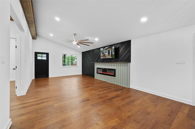 1006 Cherico St, Austin, TX 78702 - unfurnished living room featuring a glass covered fireplace, ceiling fan, wood finished floors, and recessed lighting