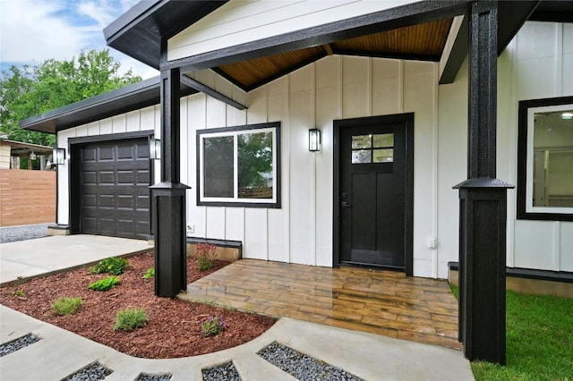 1006 Cherico St, Austin, TX 78702 - doorway to property featuring board and batten siding, an attached garage, and concrete driveway