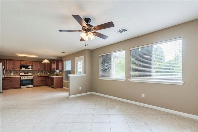 1713 Lady Grey Ave, Pflugerville, TX 78660 - kitchen featuring stainless steel appliances, tasteful backsplash, ceiling fan, light countertops, and hanging light fixtures