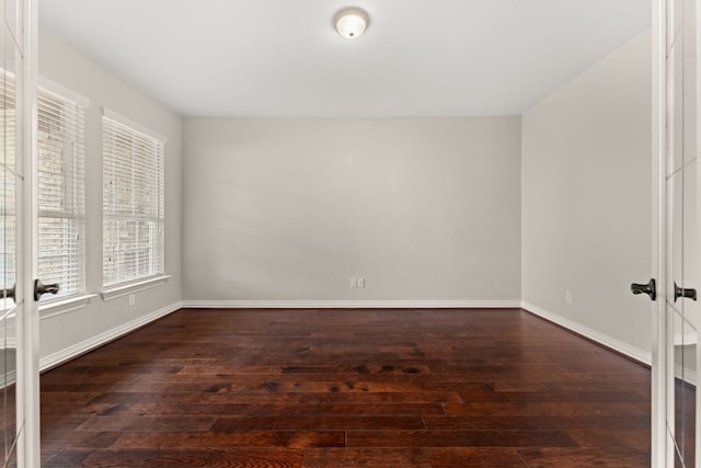 unfurnished room featuring healthy amount of natural light, wood-type flooring, french doors, and baseboards