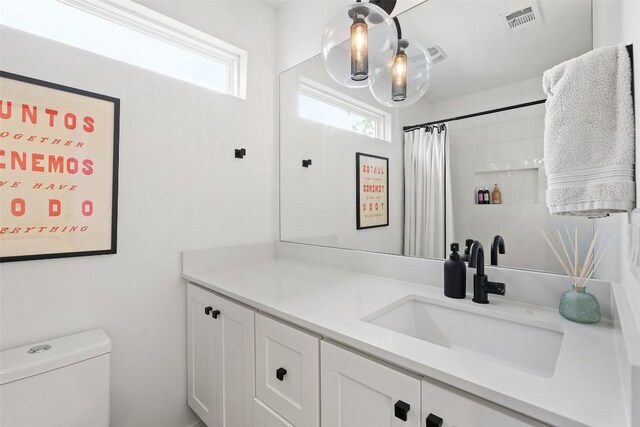 909 Mansell Ave Unit 2, Austin, TX 78702 - bathroom featuring plenty of natural light, toilet, vanity, and a shower with shower curtain