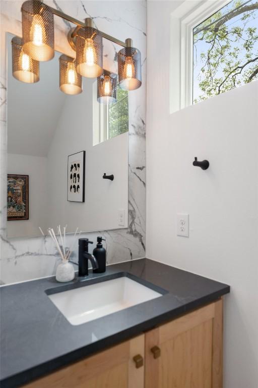 909 Mansell Ave Unit 2, Austin, TX 78702 - bathroom featuring vanity, healthy amount of natural light, and vaulted ceiling