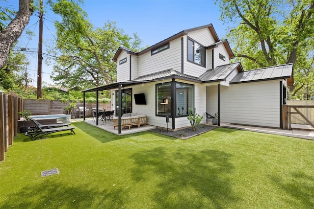 909 Mansell Ave Unit 2, Austin, TX 78702 - back of property featuring metal roof, outdoor lounge area, a patio, and a standing seam roof