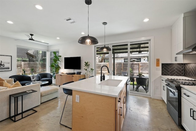 909 Mansell Ave Unit 2, Austin, TX 78702 - kitchen featuring black range with gas cooktop, a sink, concrete floors, open floor plan, and plenty of natural light
